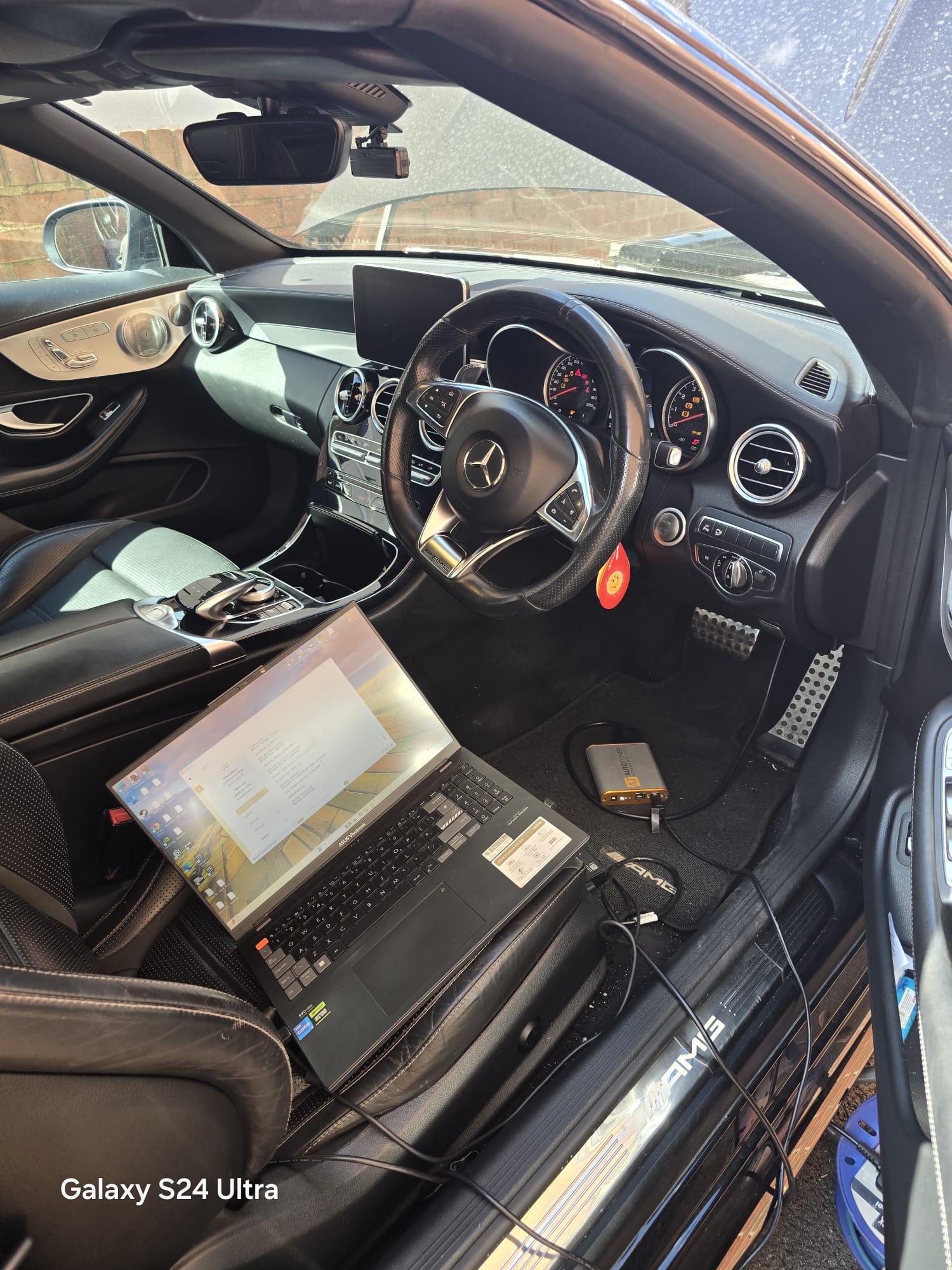 Mercedes-AMG C63 mobile ECU remap with laptop and AutoTuner connected in the cabin