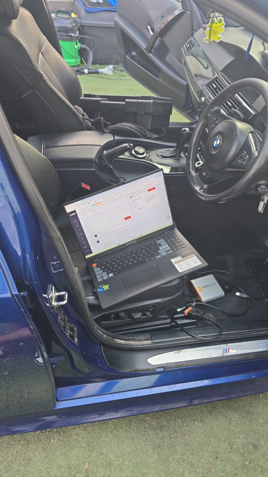BMW ECU tuning with diagnostic laptop connected on a mobile job